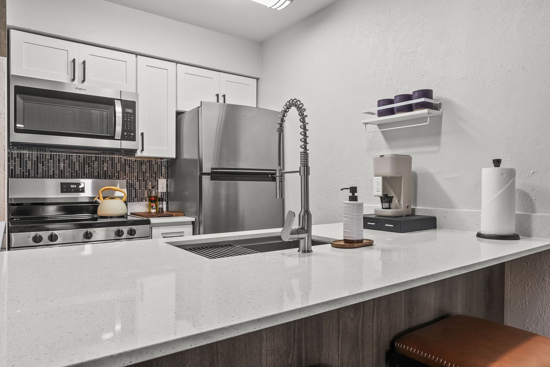 Remodeled kitchen with stainless appliances at The Modern Boho
