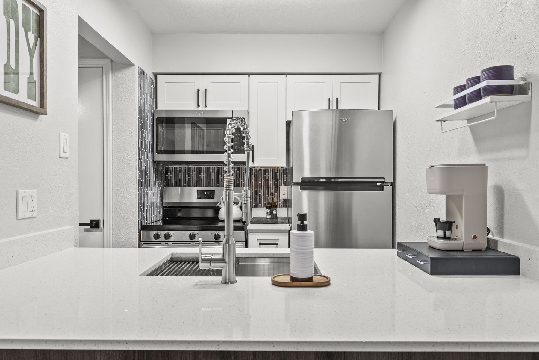 Kitchen with stainless appliances and coffee station at The Modern Boho