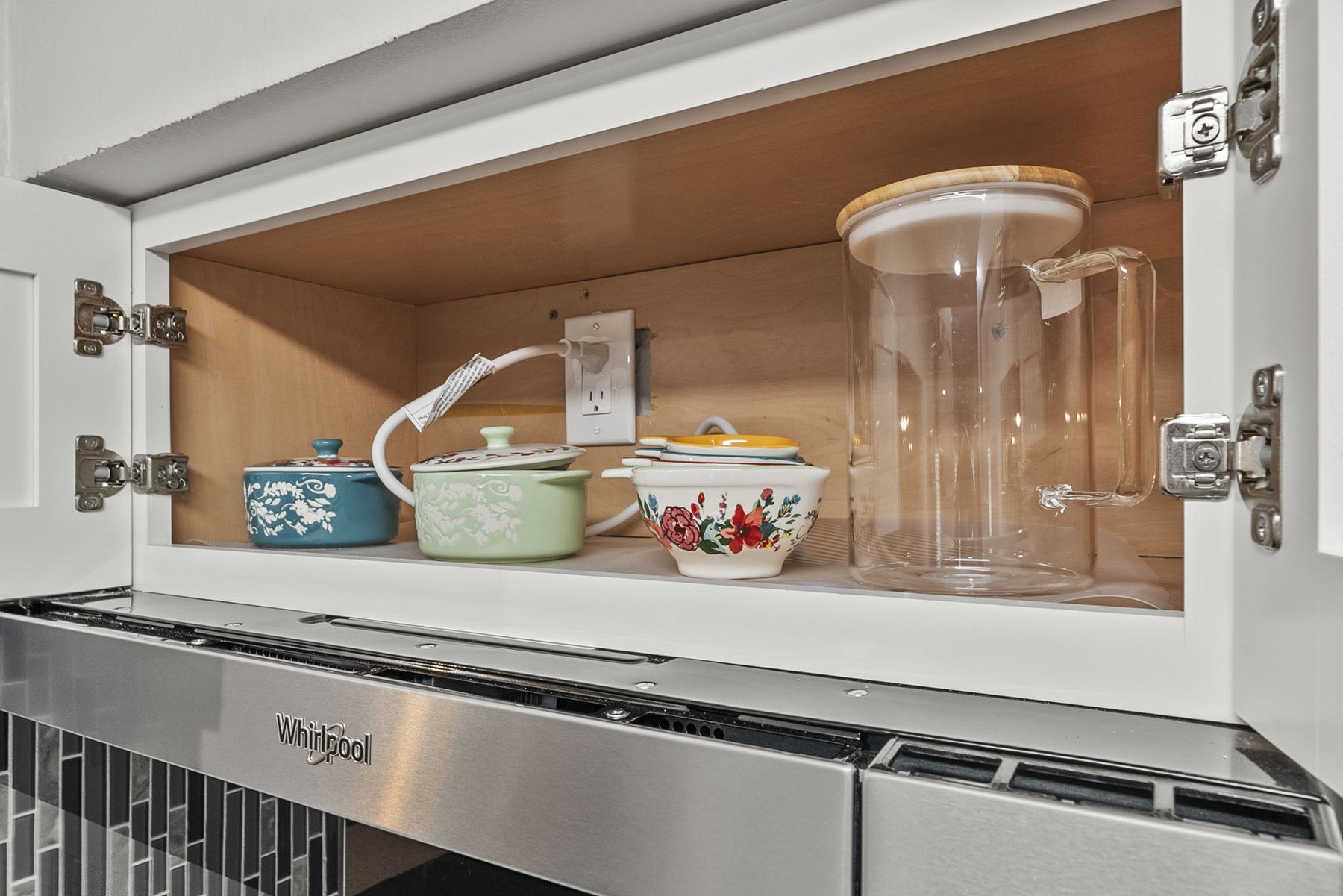 Kitchen storage with cookware and water pitcher at The Modern Boho